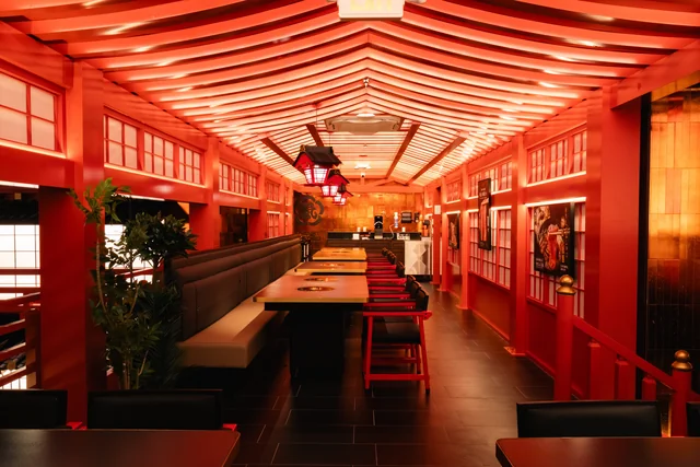 Black booths and red stools along the upstairs dining room